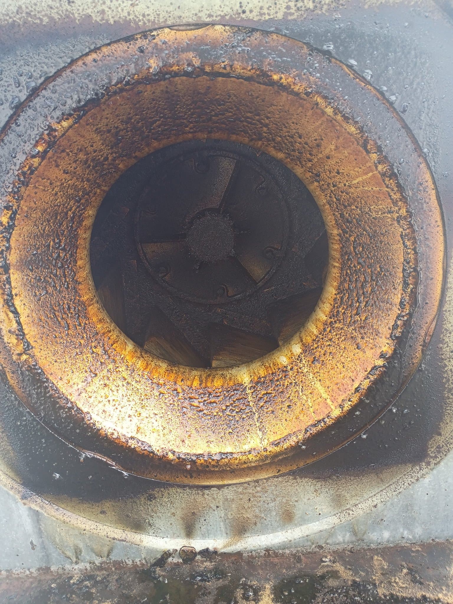Grease buildup inside a commercial kitchen exhaust fan before cleaning